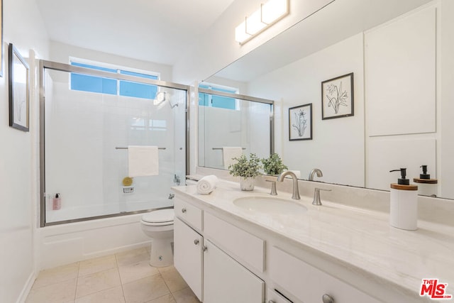 full bathroom with tile patterned floors, toilet, combined bath / shower with glass door, and vanity