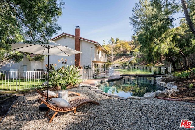 view of swimming pool with a patio