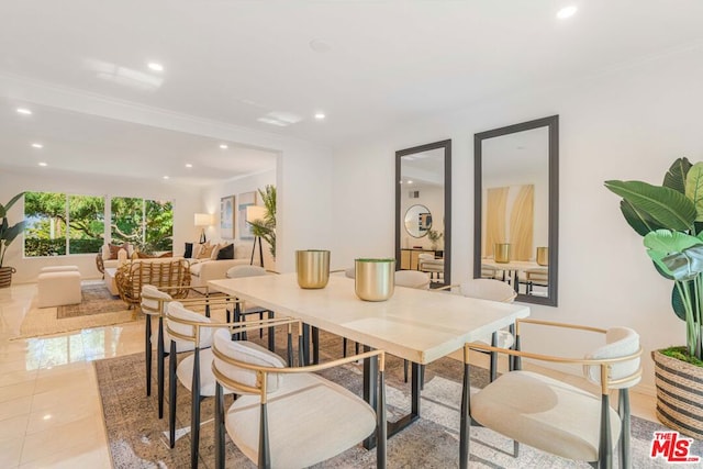 tiled dining area featuring crown molding