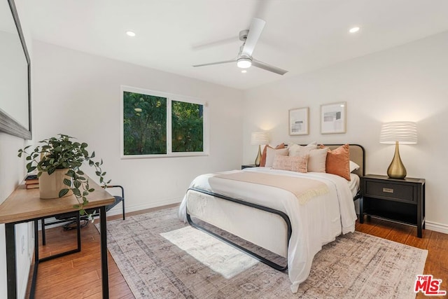 bedroom featuring wood-type flooring and ceiling fan