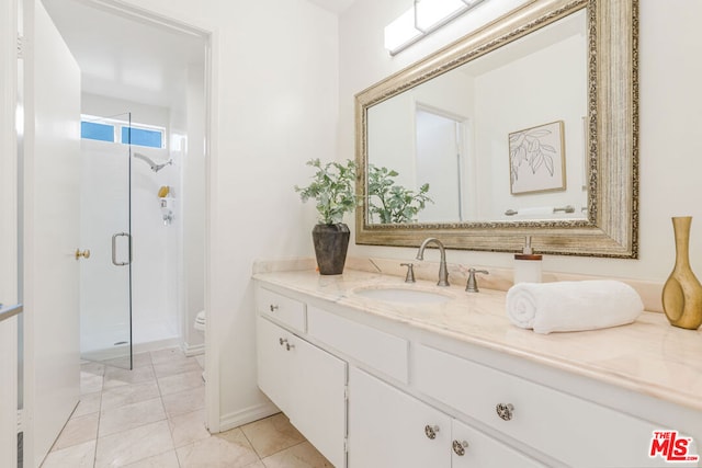 bathroom with an enclosed shower, vanity, and toilet