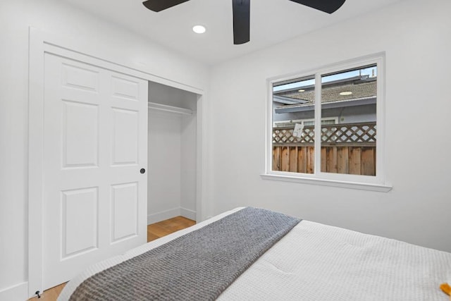 bedroom featuring ceiling fan, hardwood / wood-style floors, and a closet