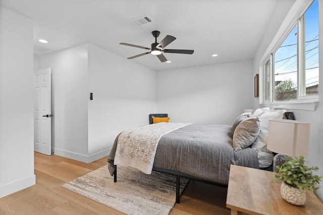 bedroom with ceiling fan and light wood-type flooring