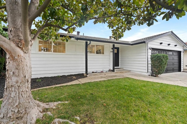 ranch-style home with a garage and a front lawn