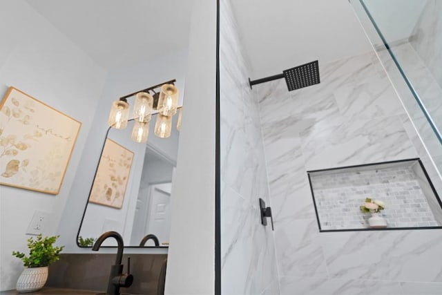 bathroom featuring a tile shower and sink