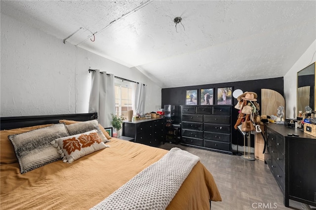 bedroom featuring parquet flooring, lofted ceiling, and a textured ceiling