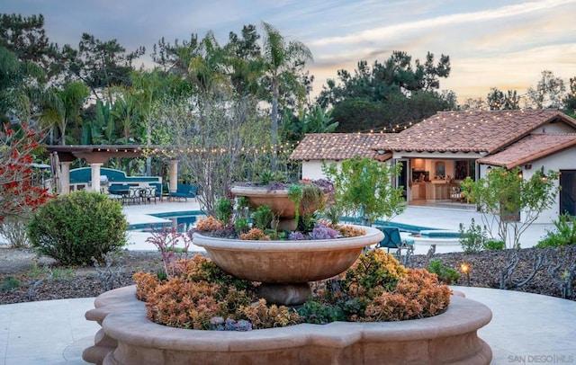 view of community featuring a swimming pool and a patio area