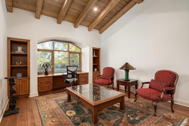 sitting room featuring beamed ceiling, hardwood / wood-style floors, and wooden ceiling