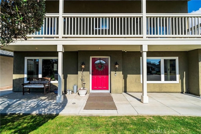 entrance to property with a balcony and a patio