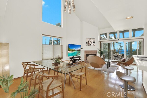 dining room with a towering ceiling and hardwood / wood-style floors