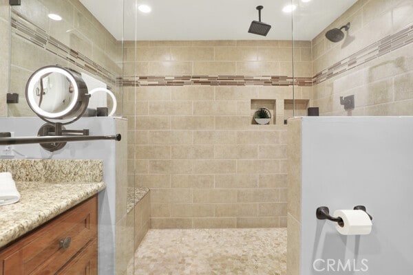 bathroom featuring vanity and a tile shower