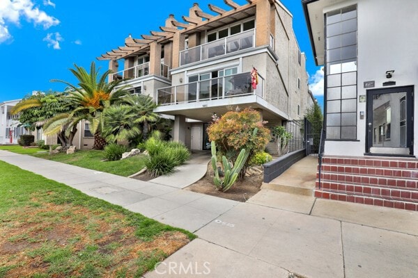 exterior space featuring a front lawn and stucco siding