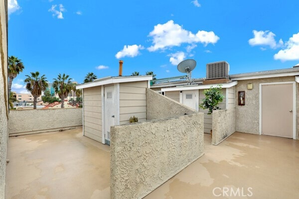 exterior space with central air condition unit, a storage shed, and an outdoor structure