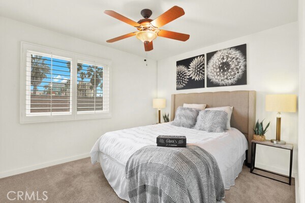 bedroom featuring light colored carpet and ceiling fan