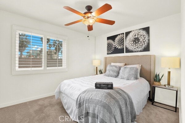 bedroom featuring ceiling fan, carpet flooring, and baseboards