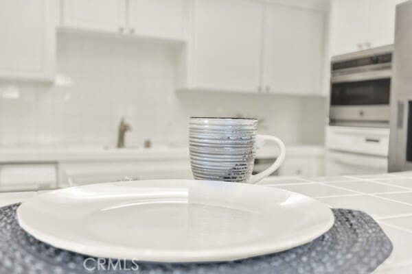 details with white cabinetry and oven