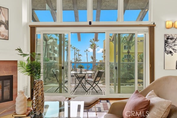 doorway to outside featuring a water view and a fireplace