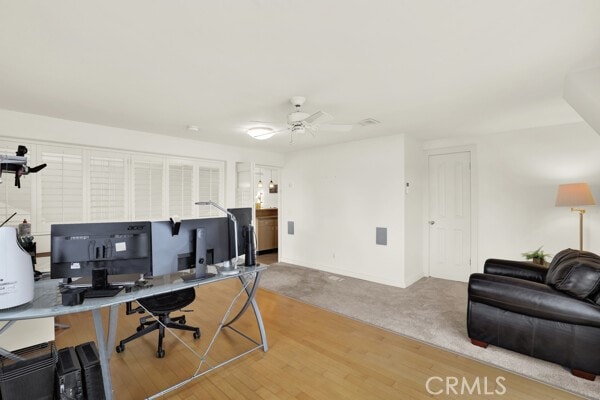 office with ceiling fan and wood-type flooring