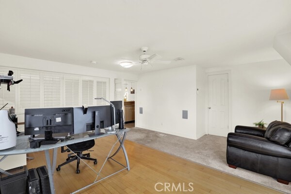 home office with ceiling fan and wood finished floors