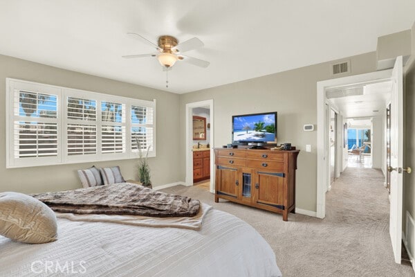 bedroom with baseboards, ceiling fan, visible vents, and light colored carpet