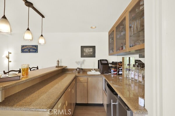 bar with dishwasher, light stone countertops, dark wood-type flooring, and pendant lighting