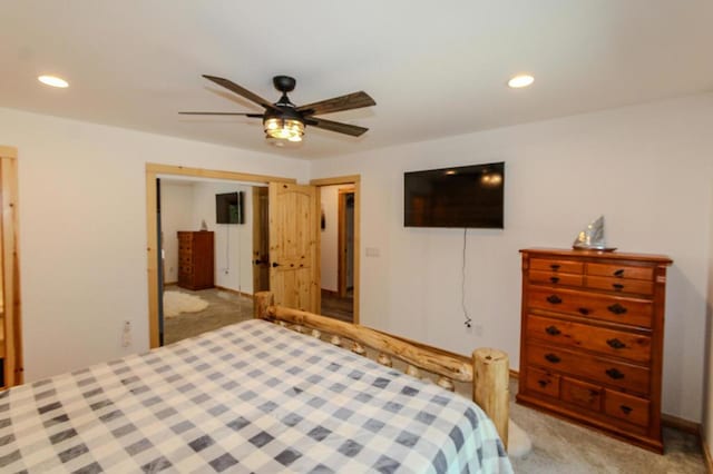 bedroom with ceiling fan, a closet, and light carpet