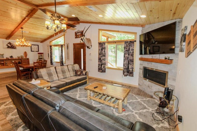 living room featuring wood ceiling, hardwood / wood-style floors, lofted ceiling with beams, a large fireplace, and ceiling fan with notable chandelier