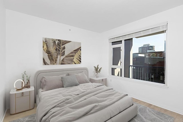 bedroom featuring wood finished floors and baseboards