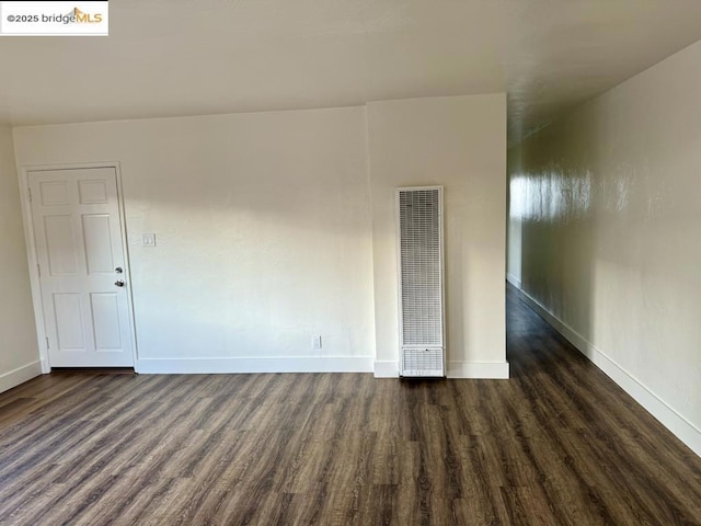 unfurnished room with dark hardwood / wood-style floors