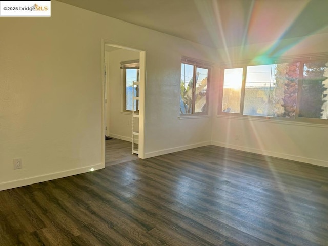 unfurnished room featuring dark hardwood / wood-style floors