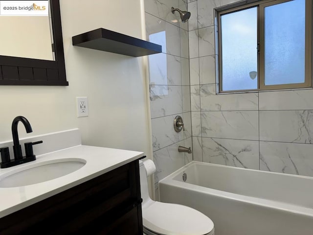 full bathroom featuring vanity, toilet, and tiled shower / bath combo