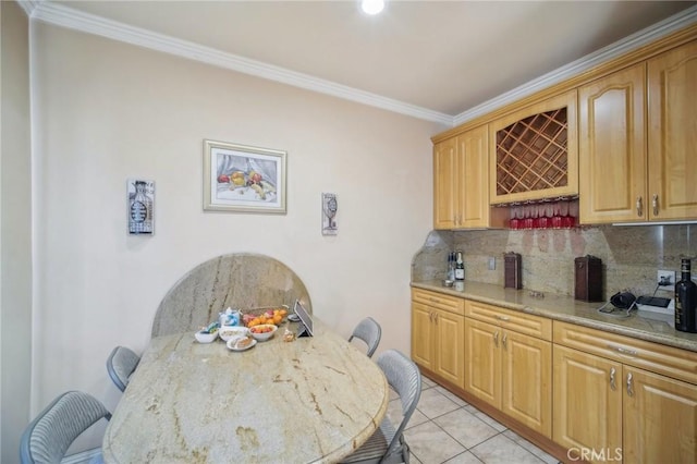 dining area with ornamental molding and light tile patterned flooring