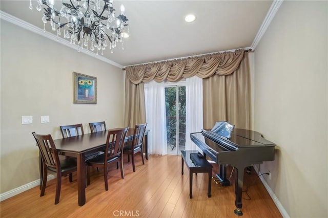 dining room with crown molding and hardwood / wood-style flooring