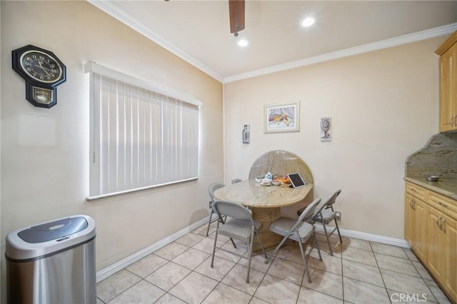 tiled dining room with ceiling fan and ornamental molding