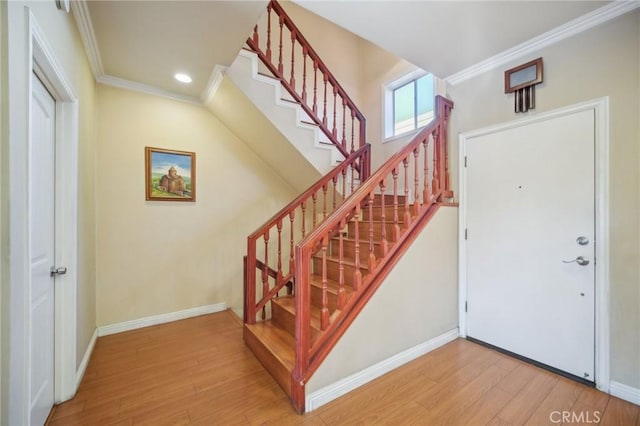 foyer featuring crown molding and wood-type flooring