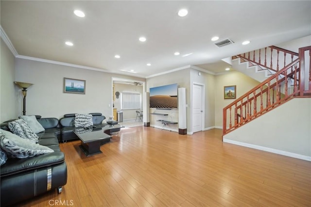 living room featuring crown molding and light wood-type flooring