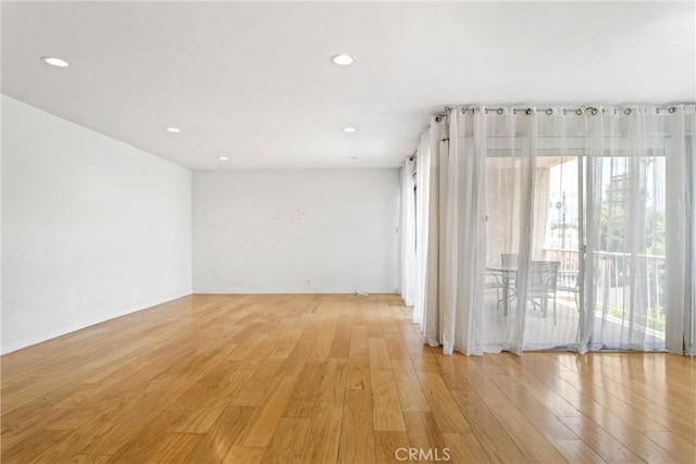 unfurnished room with light hardwood / wood-style floors