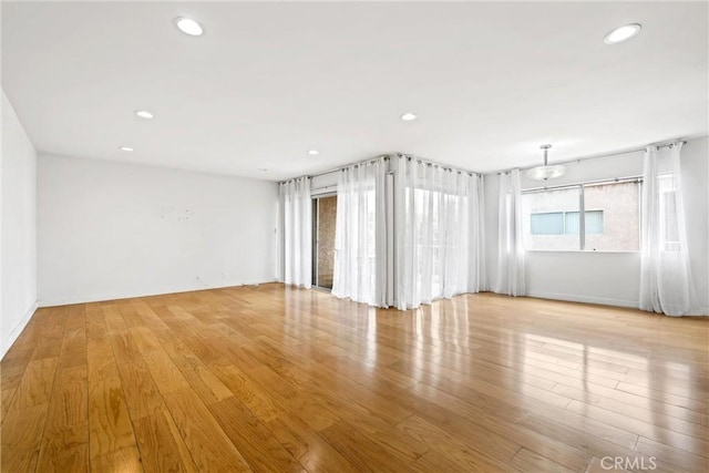 unfurnished room with light hardwood / wood-style floors and a healthy amount of sunlight