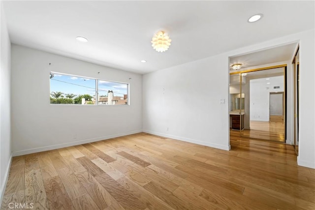 spare room with light hardwood / wood-style flooring