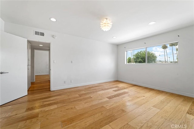 unfurnished room with light hardwood / wood-style flooring