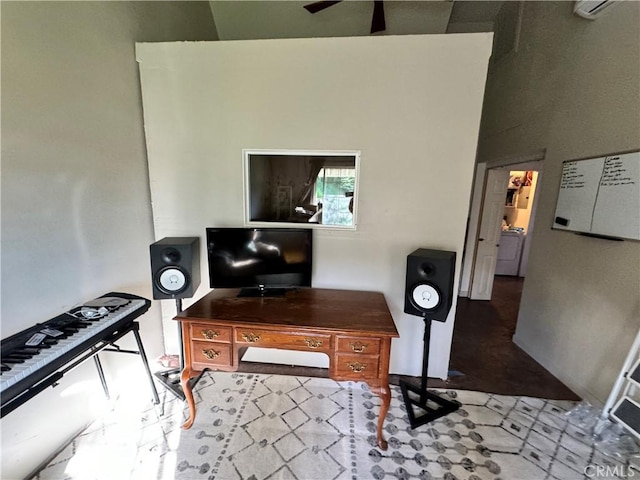 office area featuring a towering ceiling and ceiling fan