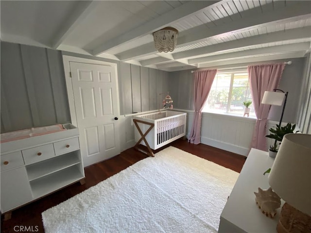 bedroom featuring dark hardwood / wood-style floors and beam ceiling