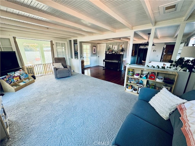 living room featuring dark wood-type flooring and beamed ceiling