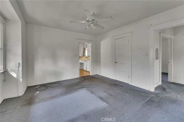 interior space featuring ceiling fan and carpet