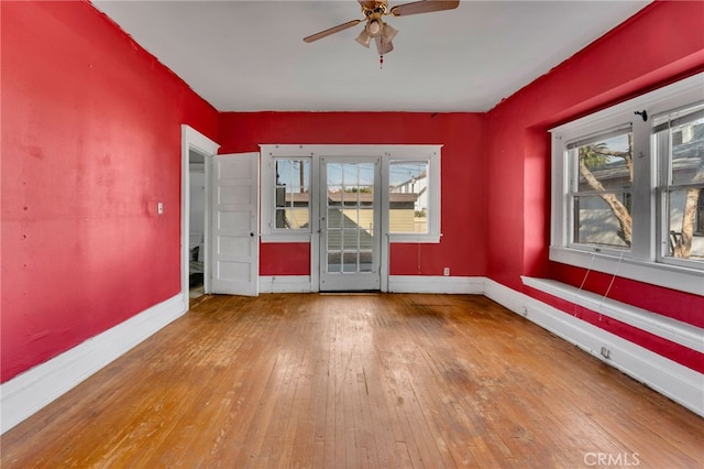 unfurnished room with hardwood / wood-style floors and ceiling fan