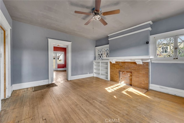 unfurnished living room featuring ceiling fan and light hardwood / wood-style floors