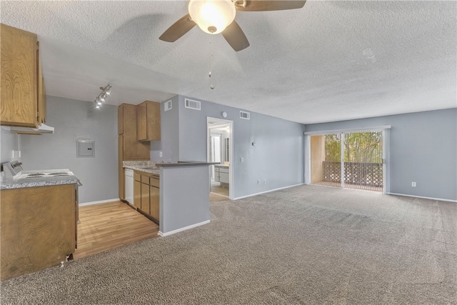 kitchen with ceiling fan, dishwasher, stove, a textured ceiling, and light colored carpet