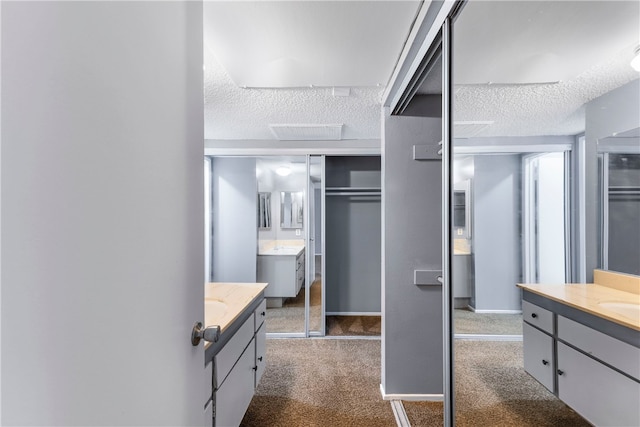 bathroom with sink and a textured ceiling