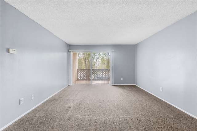 empty room with carpet and a textured ceiling