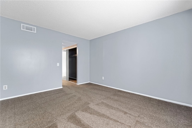 spare room with carpet floors and a textured ceiling